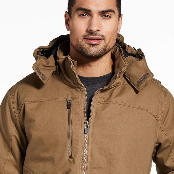 chest and face view of man wearing a brown insulated coat and dark jeans
