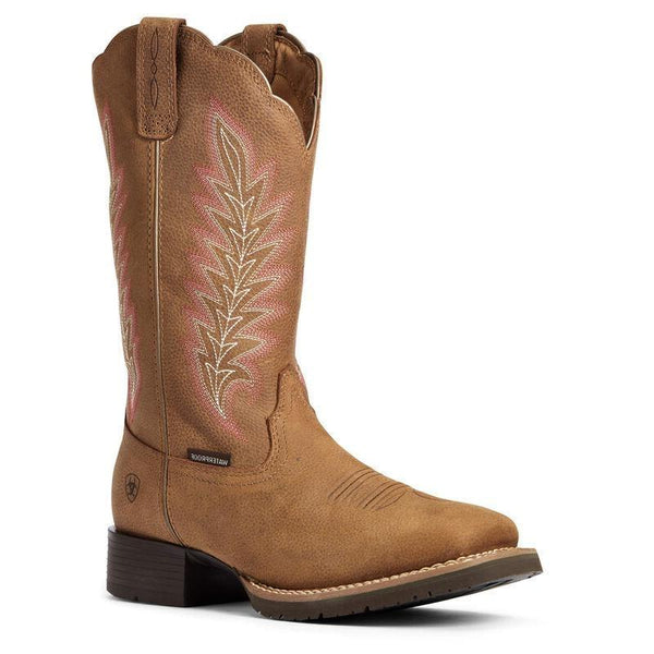 Brown cowgirl boot with a pink and white feather embroidery 