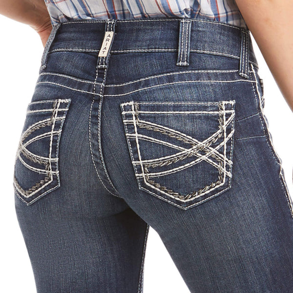 close view of back pockets of women's dark blue denim jeans with white pocket stitching details