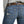 Load image into Gallery viewer, back pocket view of Woman wearing light grey shirt tucked into light blue jeans
