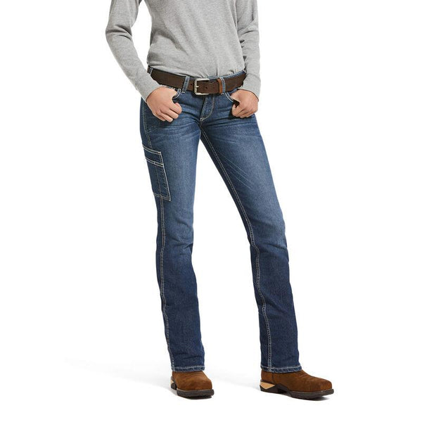 Woman wearing light grey shirt tucked into light blue jeans