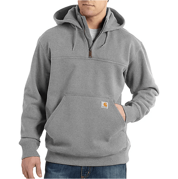 man wearing light grey hoodie with quarter zipper with one hand in pocket