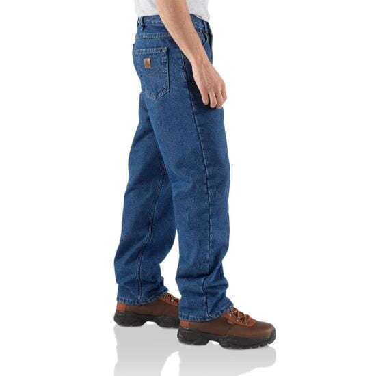 side view of man wearing relaxed dark jeans and boots