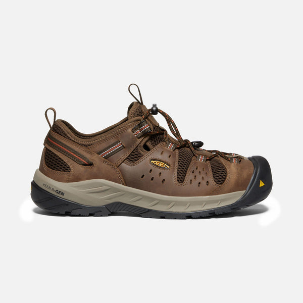 side of sneaker style brown outdoor shoes with black toe guard and brown laces
