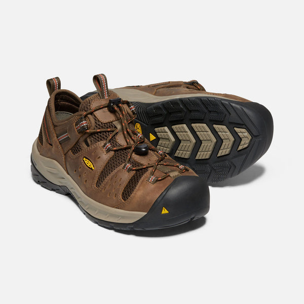 two sneaker style brown outdoor shoes with black toe guard and brown laces