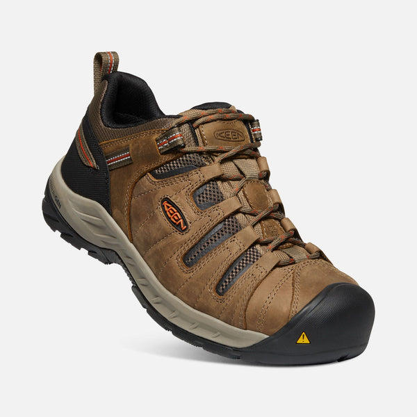 angled view of light brown outdoor shoe with black toe guard and brown laces