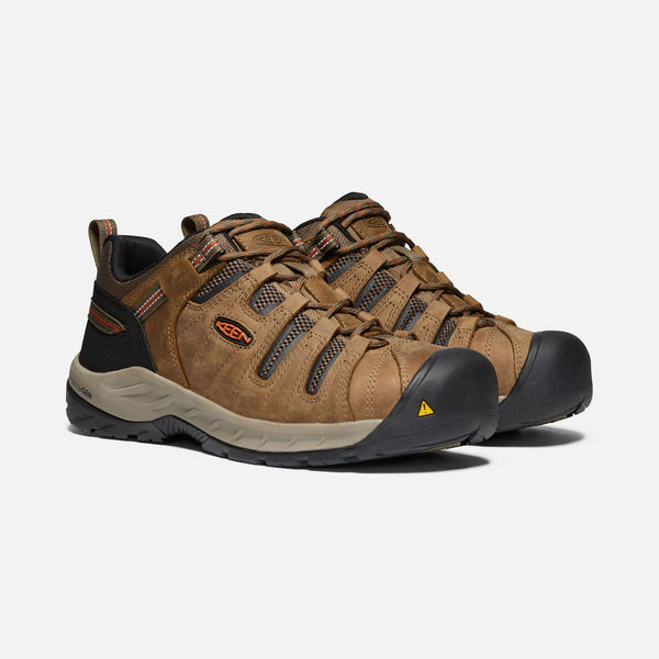 light brown outdoor shoes with black toe guard and brown laces