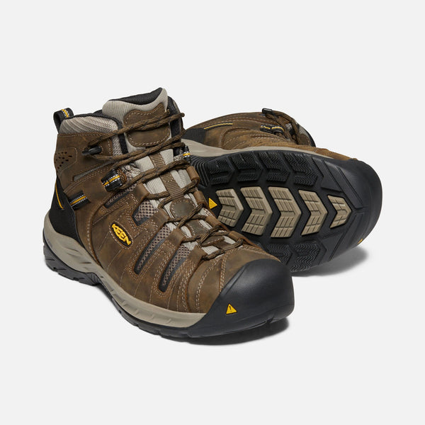 two brown outdoor shoes with black toe guard and heel and brown laces