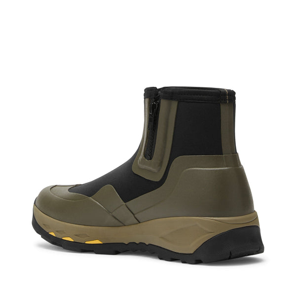 side rear view of black and olive green low top rubber boot with side zipper and tan sole