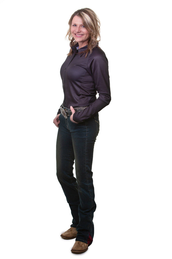 woman wearing dark blue jeans and black long sleeve shirt with thumbs in front pockets