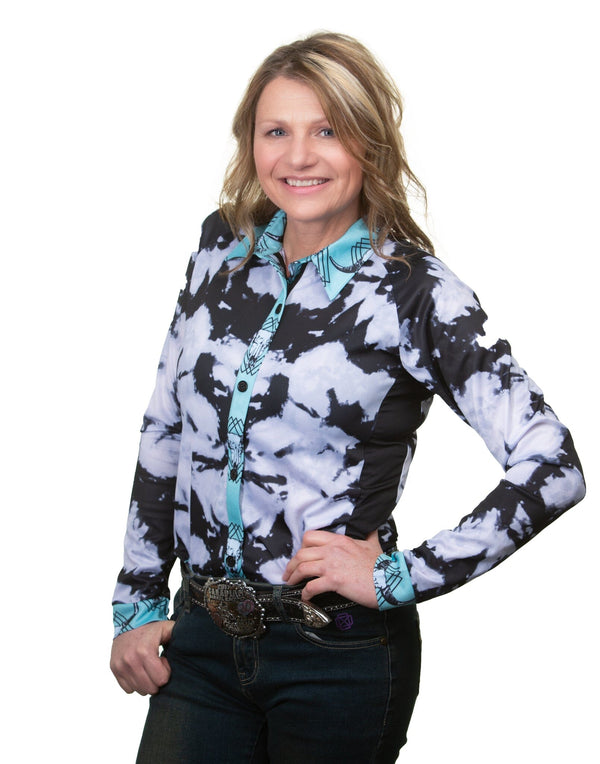 woman wearing black and white tie dye long sleeve button up shirt with turquoise accents.