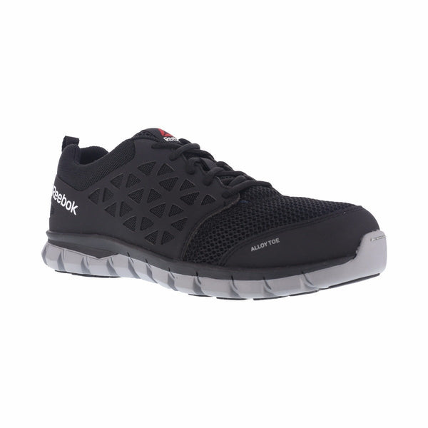 black shoe with grey sole. triangle pattern on side. reebok on heel