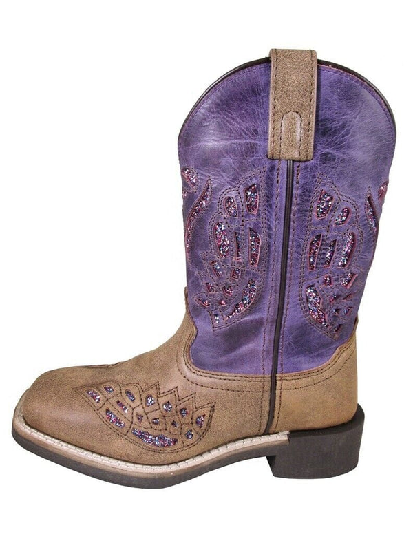 left side of kids square toe pull on cowgirl boot with brown vamp, purple shaft, and glitter underlay in cut out designs