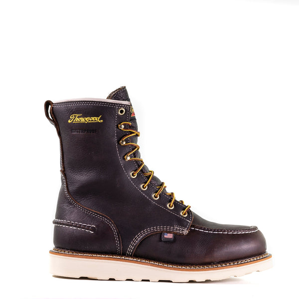 right side view of dark brown high top moccasin style boot with yellow thorogood logo embroidered on shaft and white wedge sole