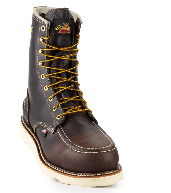 front angled view of dark brown high top moccasin style boot with yellow/brown laces and thorogood logo on top of tongue.