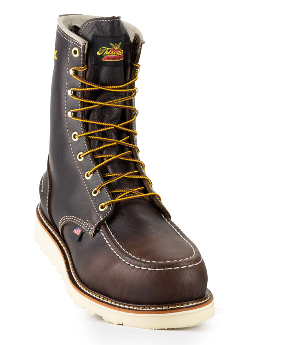 front angled view of dark brown high top moccasin style boot with yellow/brown laces and thorogood logo on top of tongue.