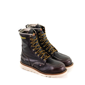 pair of dark brown high top moccasin style boots with yellow and brown laces and white wedge soles