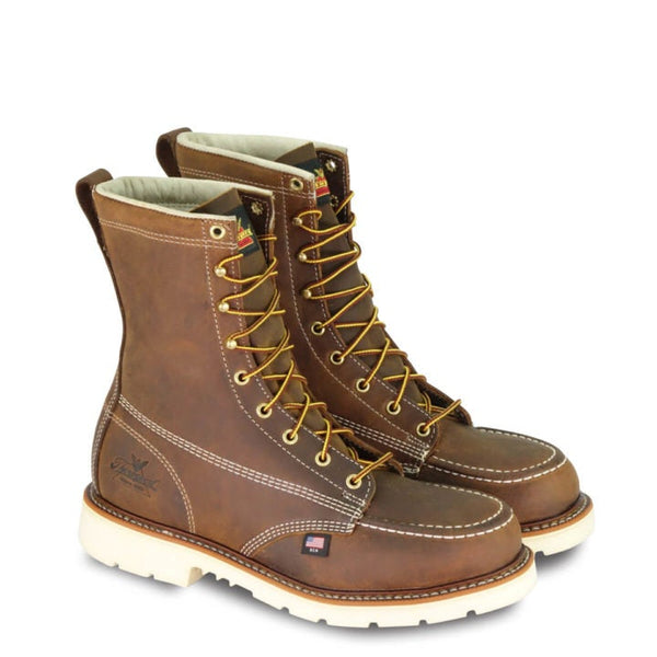 mens rugged brown logger boot with white interior, sticthing, and sole. Black thorogood logo stamped on heel with gold/red laces.