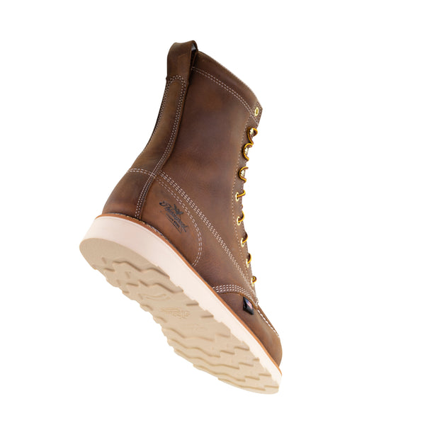back angled view of mens brown logger boot with white sole and stitching and thorogood logo on heel.