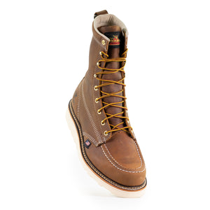 front angled view of mens brown logger boot with white sole and stitching and thorogood logo on tongue. yellow/brown laces.