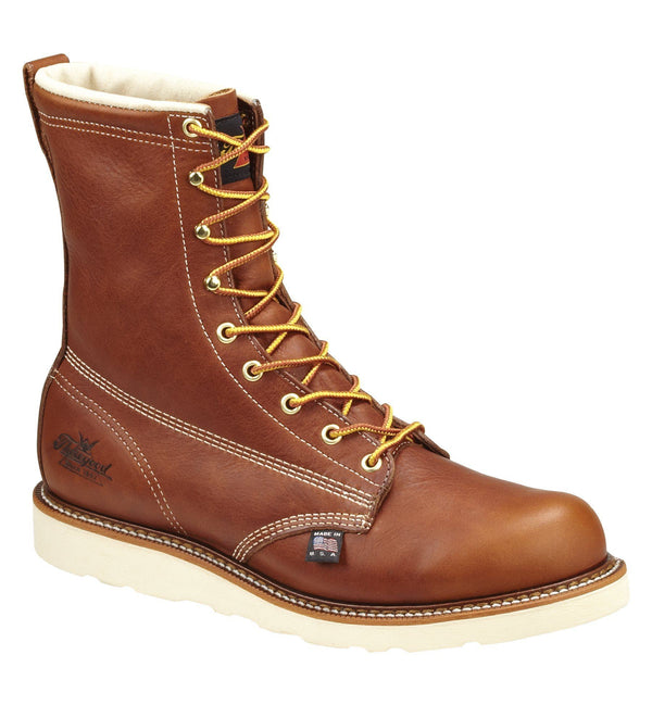 mens brown logger boot with white interior, sticthing, and sole. Black thorogood logo stamped on heel with gold/red laces. right corner view