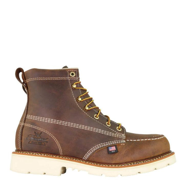 Side profile of mens six inch brown logger boot with cream interior, sticthing, and sole. Thorogood logo stamped on heel with gold/red laces.