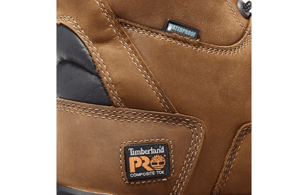 mens brown logger boot with orange line along tan soles. Black toe and tongue zoomed in of patch