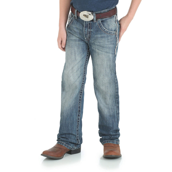boy in navy shirt and big brown belt with faded jeans