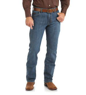 Man in Dark Brown Solid button up  and brown belt in rough blue jeans