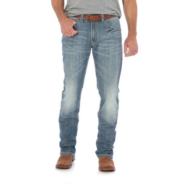 man in grey shirt in rough faded jeans