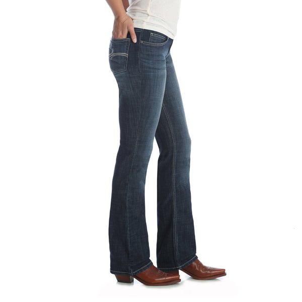 woman in white wearing dark blue jeans side angle