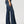 Load image into Gallery viewer, side view of women wearing wide leg blue jeans with tan boots and hand at her side
