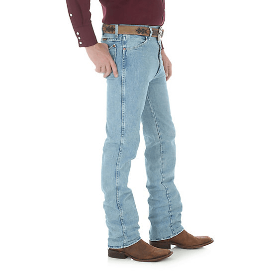 Man in light blue jeans wearing brown belt & boots side angle