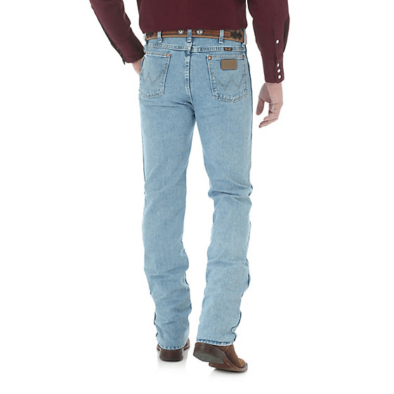 Man in light blue jeans wearing brown belt & boots back angle